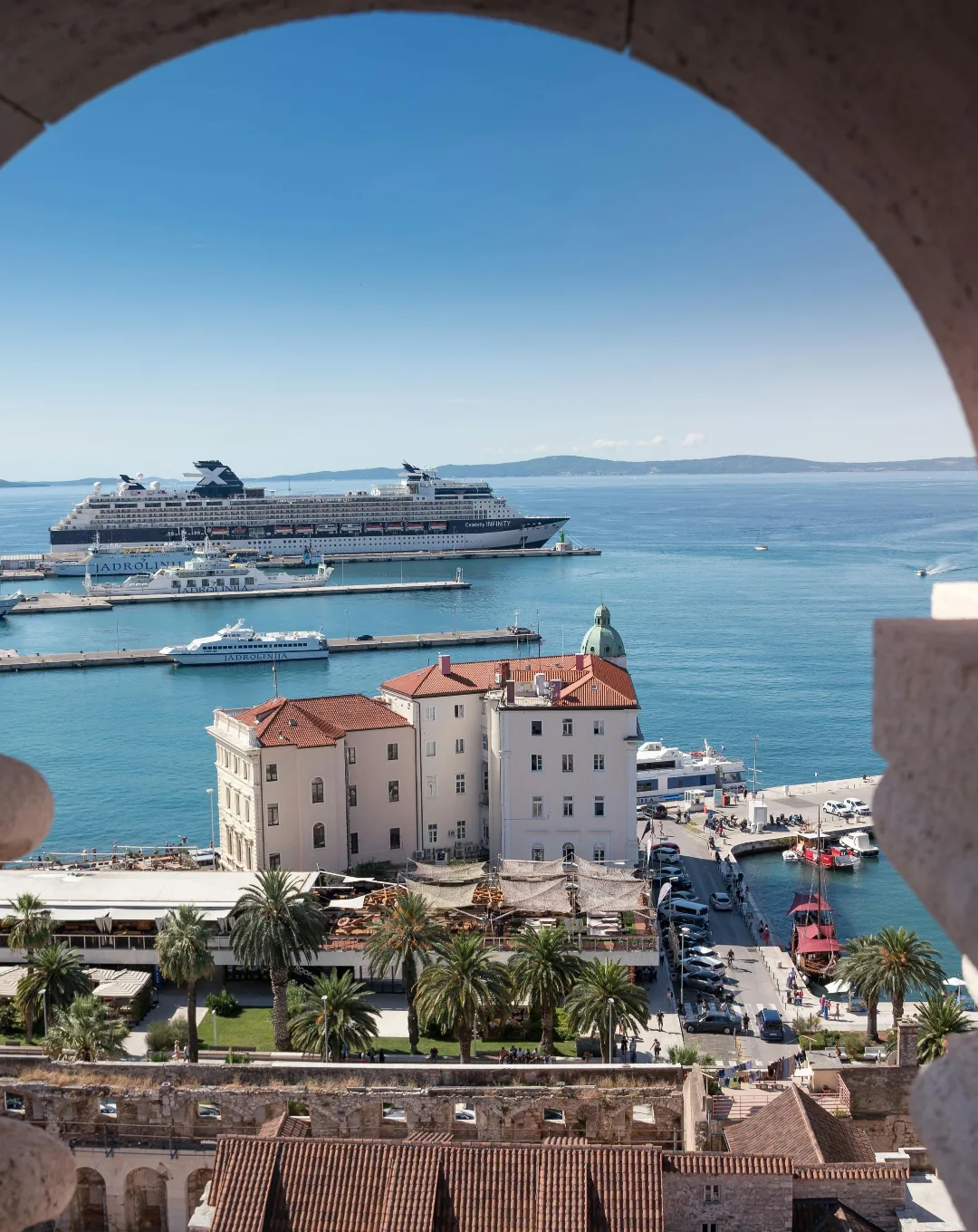 Cruise ship seen through a stone arch on the Adriatic