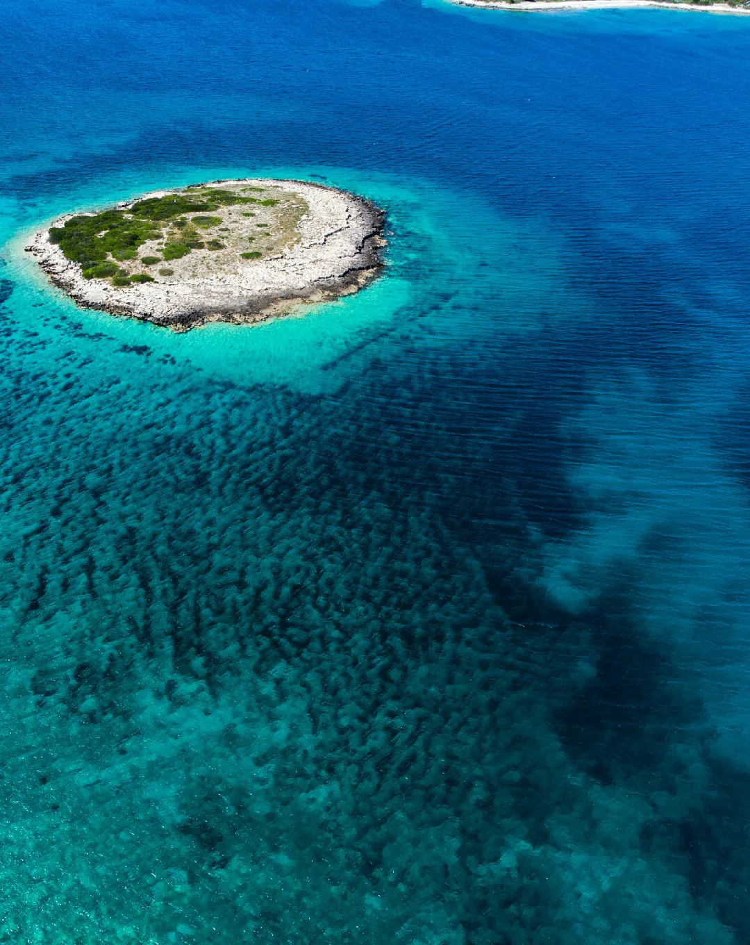 Aerial view of a small island in turquoise water