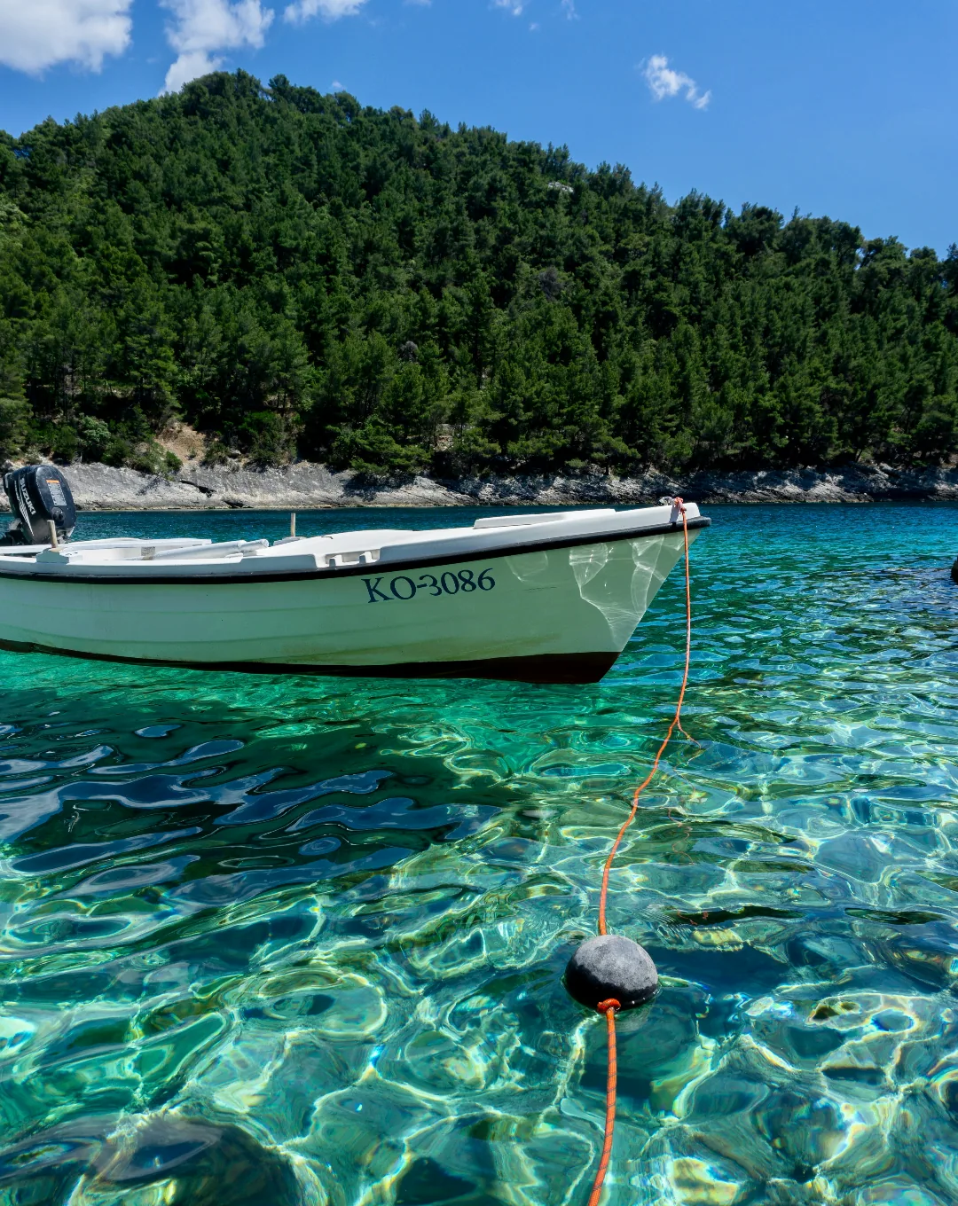 Boat moored in clear turquoise water