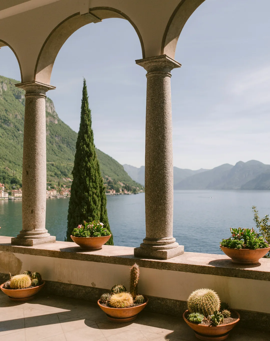 Lakeside terrace with columns overlooking an Italian lake