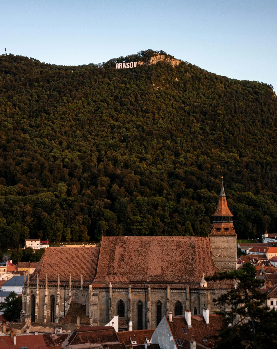 Brasov old town and the Black Church below the forested mountain