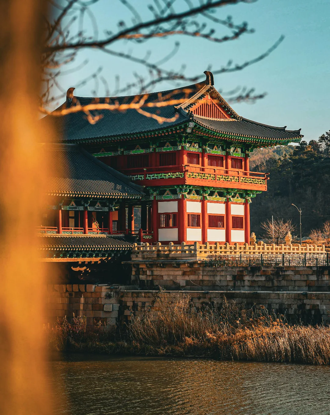 Traditional Korean pavilion by the water in autumn