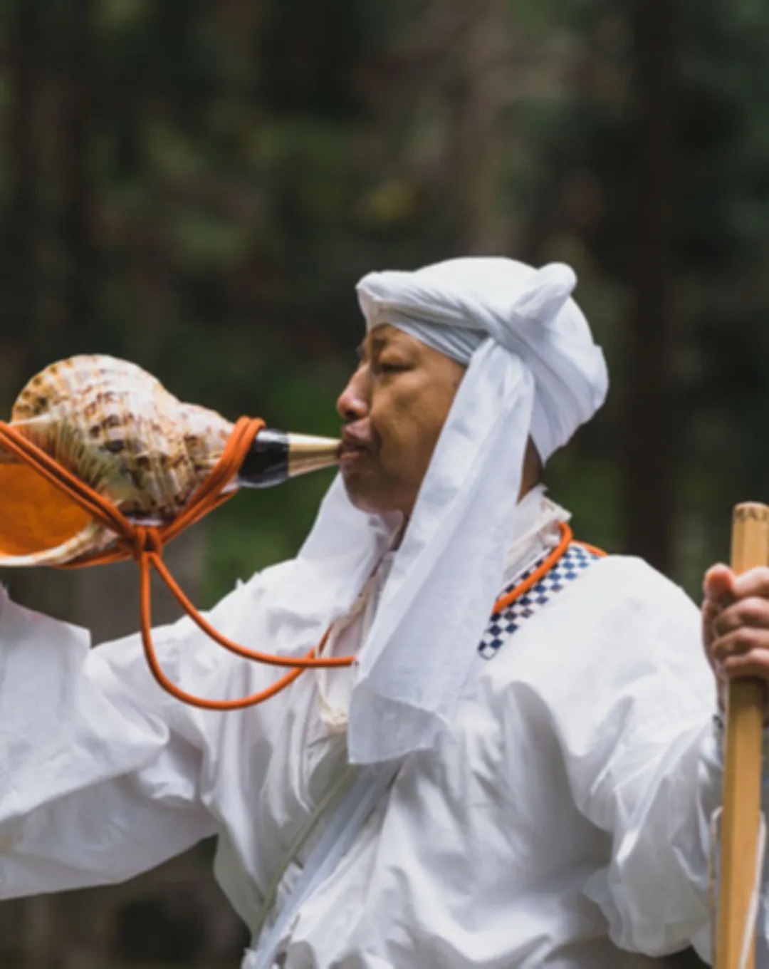 Mountain ascetic blowing a conch shell in Japan